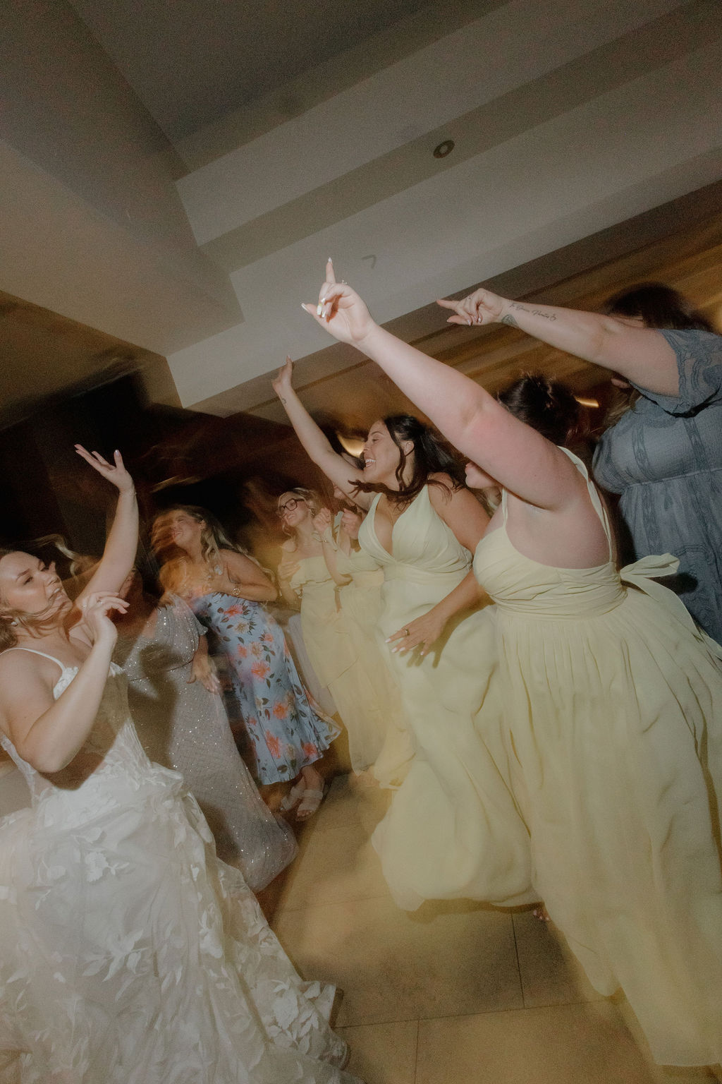 A bride dancing with bridesmaids on the dance floor