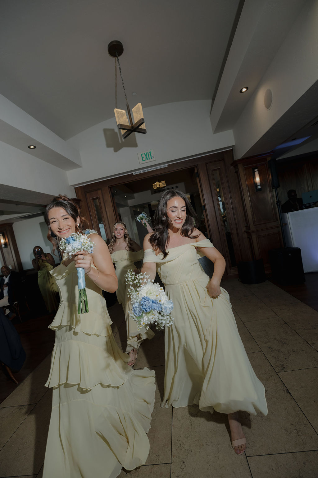 Bridesmaids entering a wedding reception 