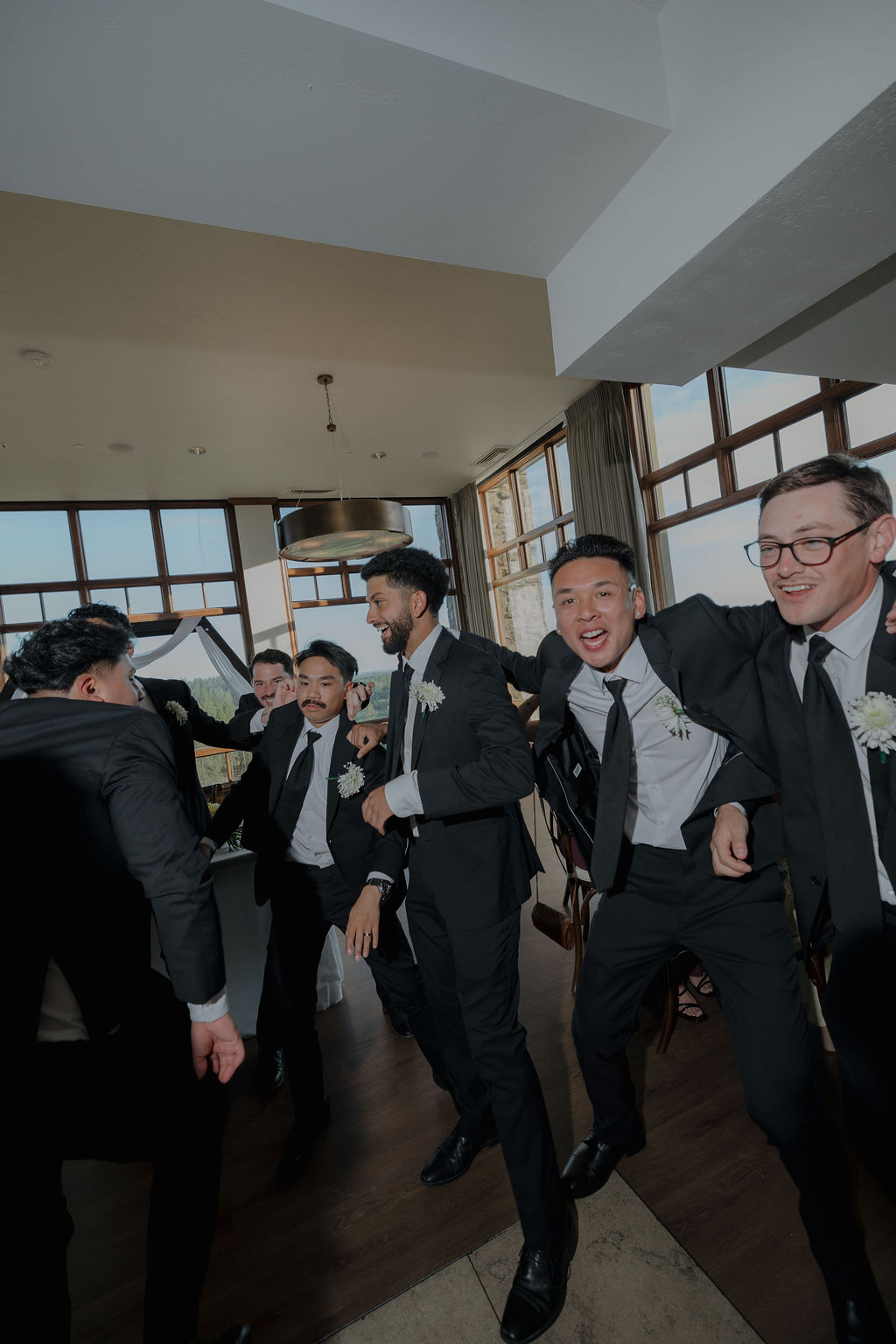 Groomsmen entering a wedding reception 