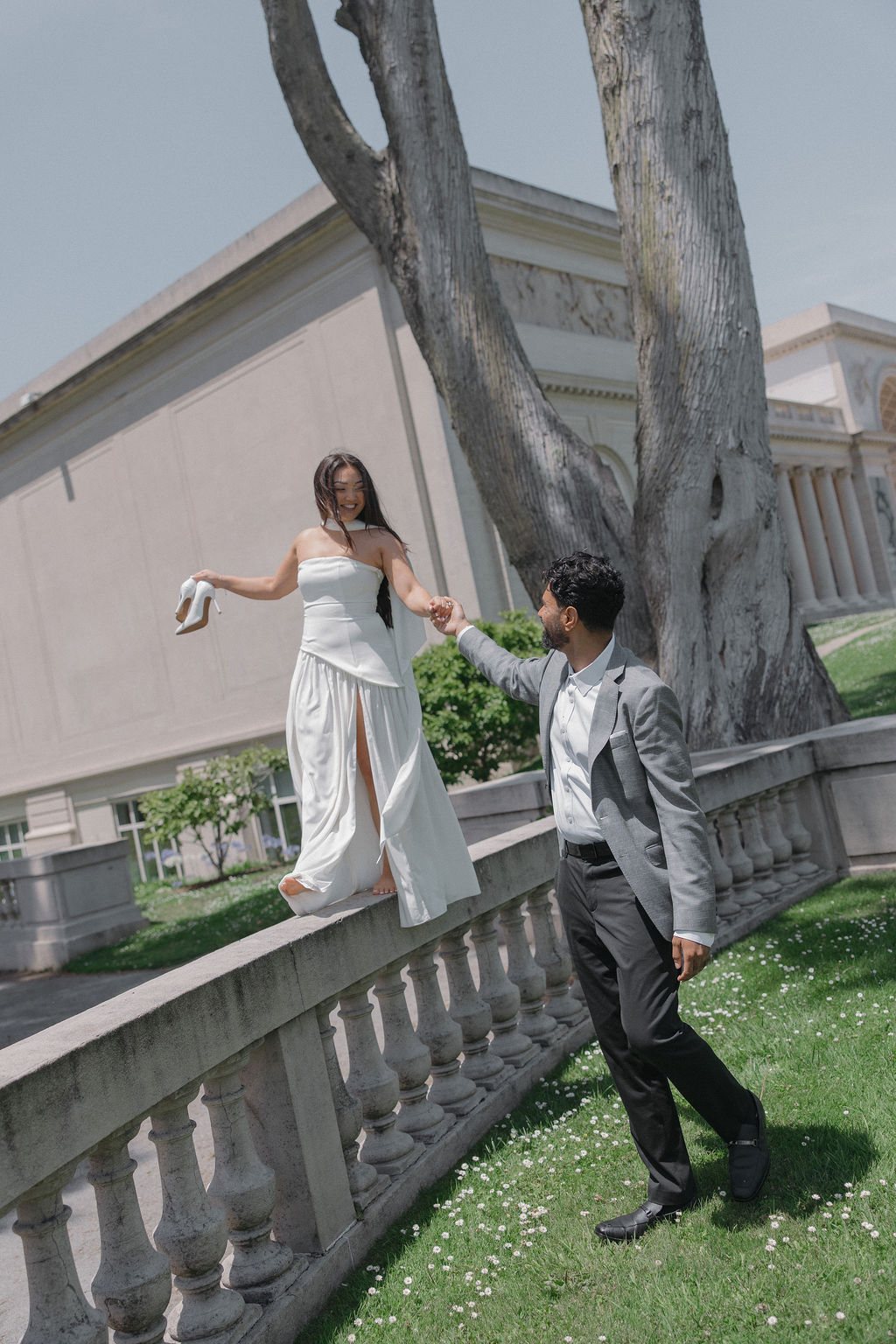 A bride walking on a walkway for luxury engagement photos