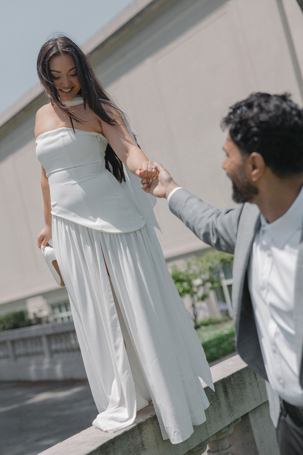 A bride walking on a walkway for luxury engagement photos